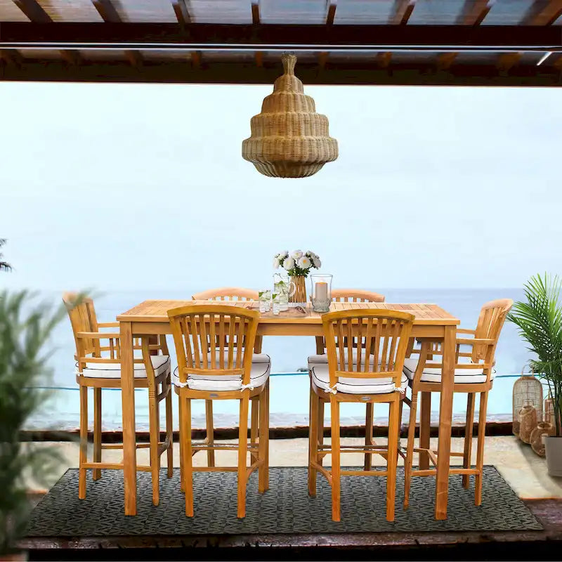 Ensemble de bar bistro de patio Chic Teak Orleans en bois de teck, 7 pièces : table de bar de 63 pouces, 2 chaises de bar avec accoudoirs et 4 chaises de bar sans accoudoirs.