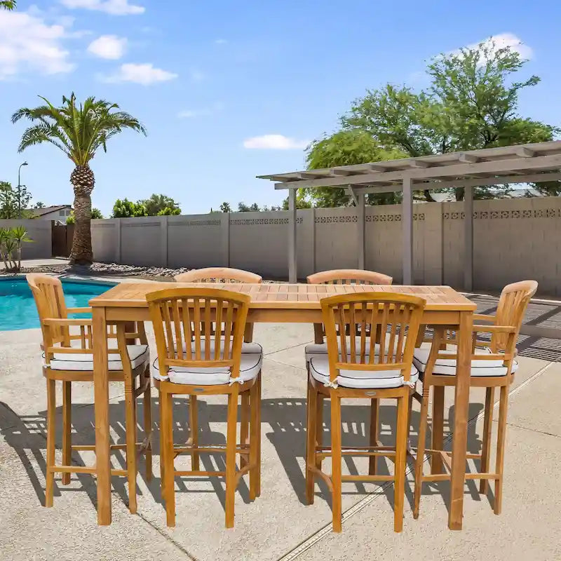 Ensemble de bar bistro de patio Chic Teak Orleans en bois de teck, 7 pièces : table de bar de 63 pouces, 2 chaises de bar avec accoudoirs et 4 chaises de bar sans accoudoirs.