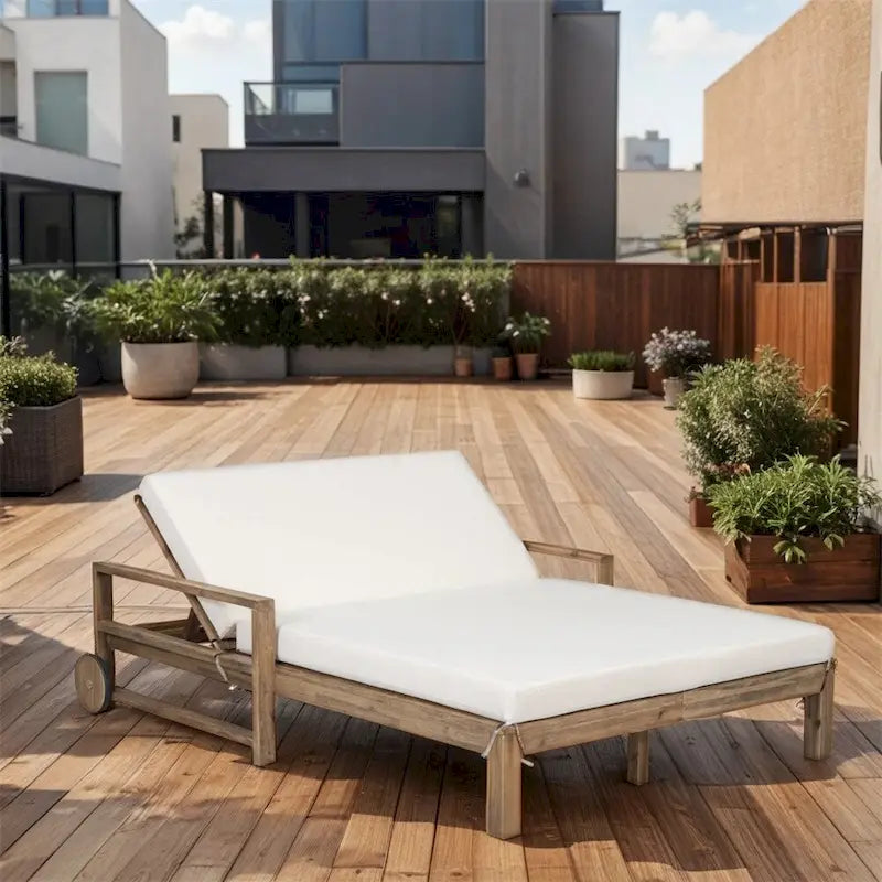 Lit de jour d'extérieur en bois monobloc avec coussins en tissu